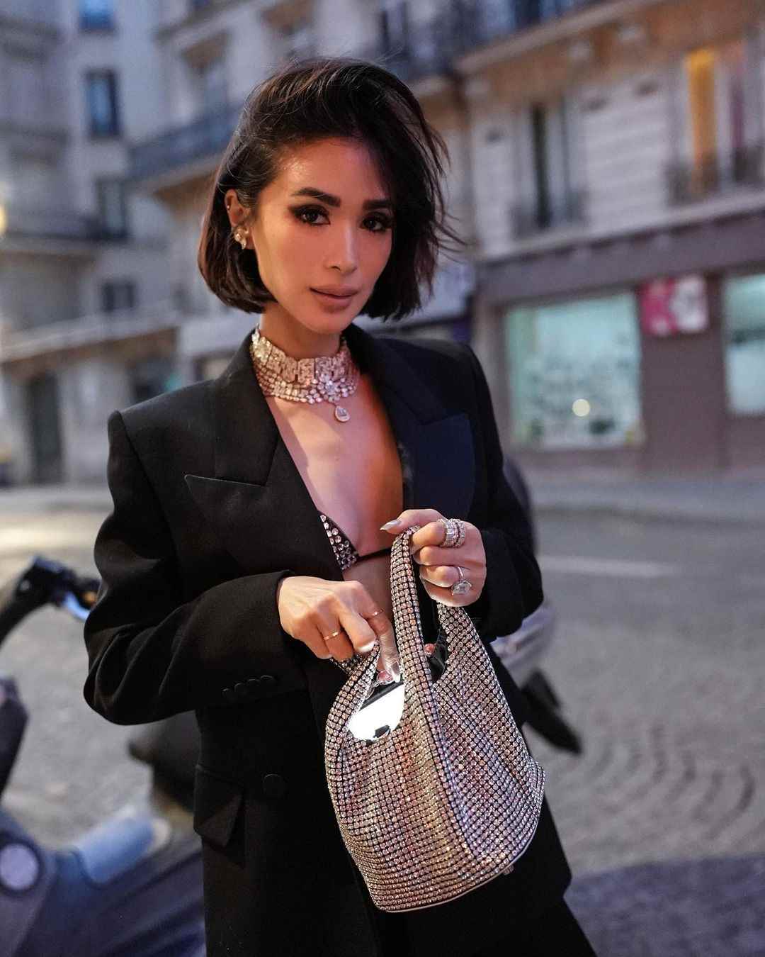 Heart Evangelista with Giarite Handbag, a prominent Filipino actress, socialite, and fashion icon, known for her distinctive style and presence at fashion events.