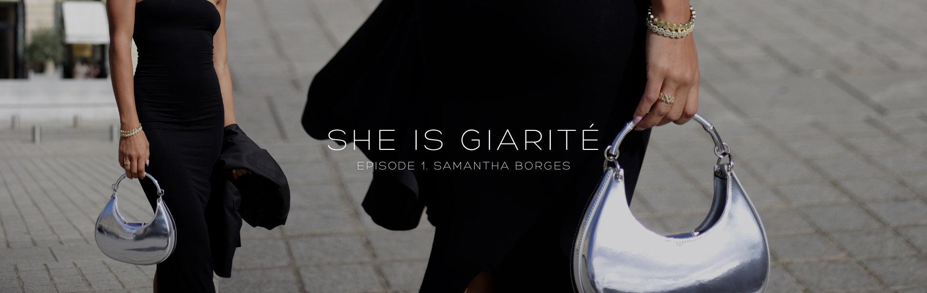 A woman holds a silver, crescent-shaped Giarité Luna bag while walking, complemented by a black dress and gold accessories. The image also contains text "SHE IS GIARITÉ EPISODE 1 SAMANTHA BORGES". 